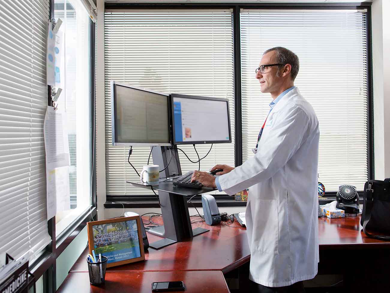Male physician working on a computer