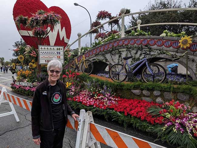 Lynn standing in front of the KP Rose Parade float