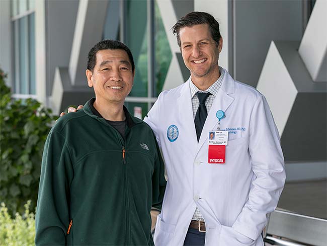 Rong Fang with cardiologist Matthew Solomon, MD, whose quick diagnosis of a ruptured heart valve saved the 54-year-old’s life. 