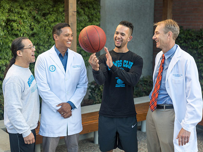 Young man and his father with basketball and physicians