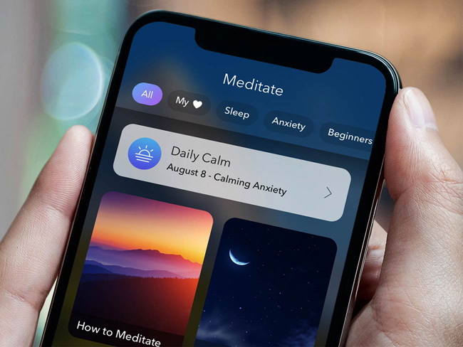 Hand holding a phone with the Calm app screen